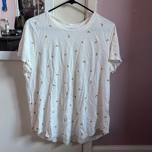 White T-shirt with sunflowers all over it